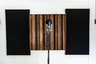Microphone in front of acoustic wall treatment in the recording room